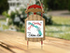 Ornament shaped like a red and wood sled with "Merry Christmas from Eklutna Lake" text.