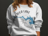 White sweatshirt with Pactola Lake, South Dakota map and compass design.