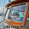 "Wenatchee Life" sticker on tinted window of a boat with "Lake Lodge Media" logo.