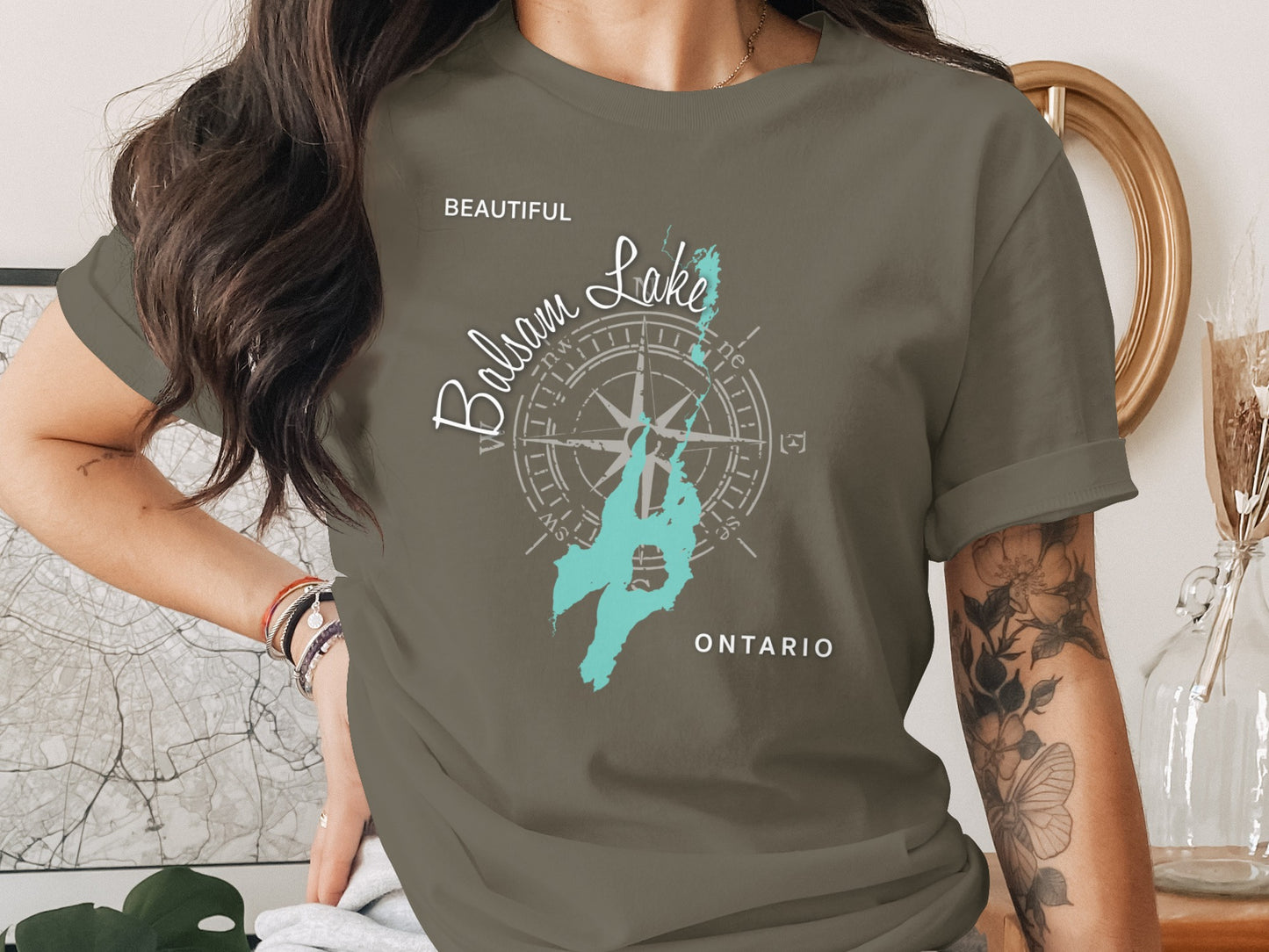 Green t-shirt with compass rose graphic and "Balsam Lake, Ontario" text.