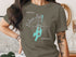 Green t-shirt with compass rose graphic and "Balsam Lake, Ontario" text.