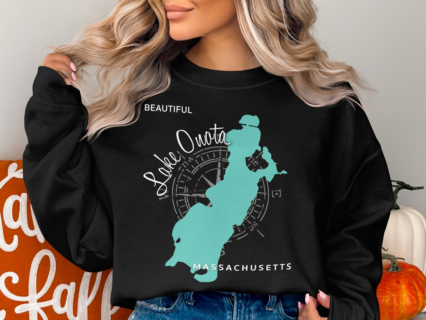 Black sweatshirt with a teal outline of Lake Quaboag, Massachusetts and compass rose.
