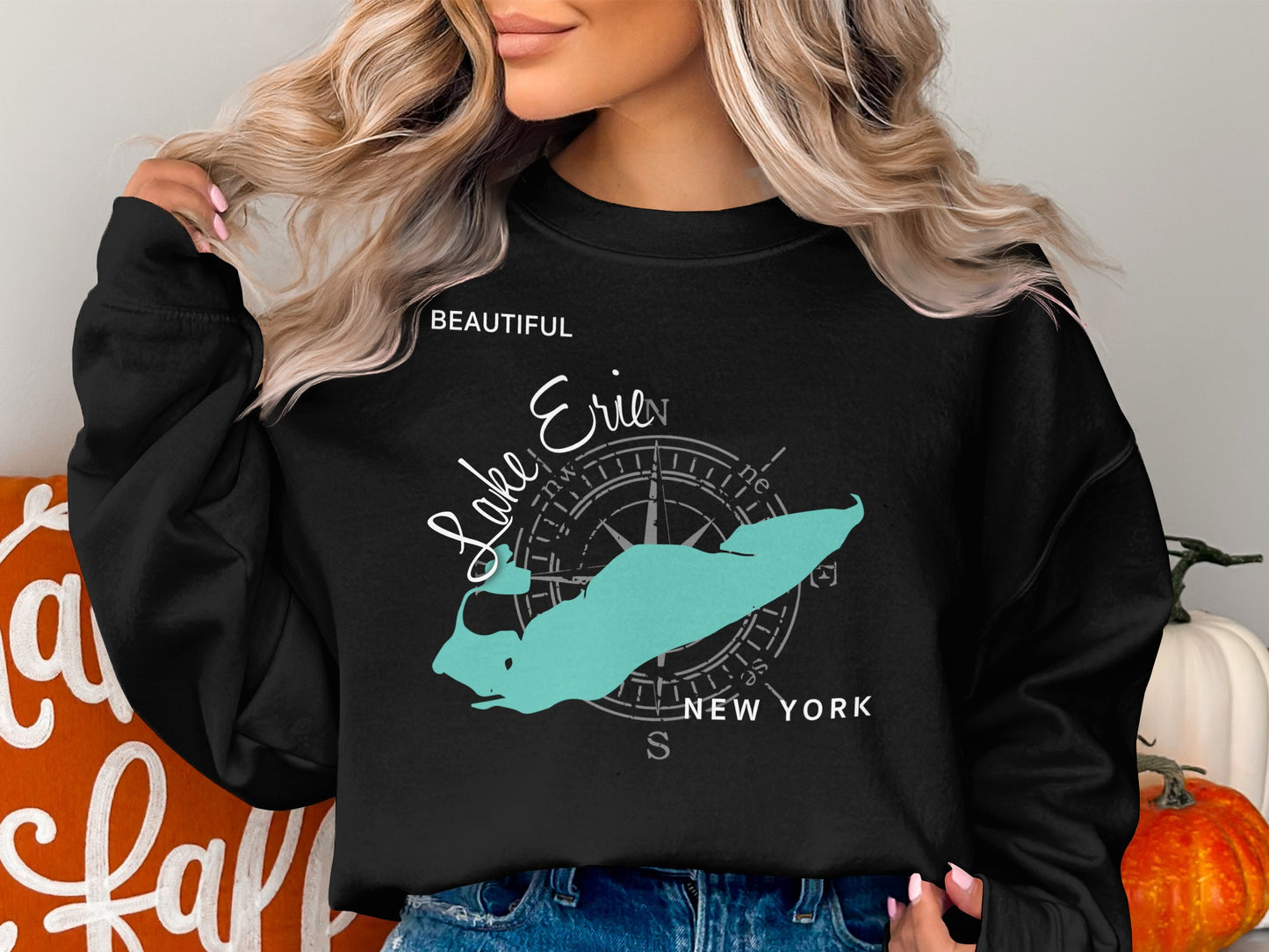 Black crewneck sweatshirt with turquoise Lake Erie map and compass graphic.