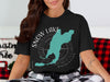 Black t-shirt with Snow Lake Washington map and compass graphic.