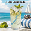 Glass with drink, limes, mint, and "Killer Ferry Lake" text on beach background.