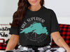 Black t-shirt with teal Lake Superior map and compass graphic.