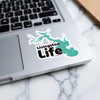 Livingston Life sticker on a laptop keyboard.