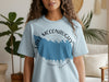 Light blue t-shirt with Lake McConaughy Nebraska design and compass graphic.