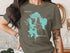 Olive t-shirt with a teal map of Lake Massabesic, New Hampshire, and compass rose.