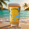 Beer glass with Lake Texoma map and compass design on a beach.