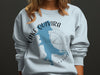 Light blue sweatshirt with "Lake Quivira Kansas" map and compass graphic.