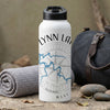 White water bottle with "LYNN LANE" text and compass design on stone surface.