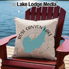 Pillow with Rose Canyon Lake Arizona map and compass on a red chair.