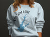 Light blue sweatshirt with Folsom Lake California map and compass design.