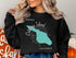 Catalina Island map graphic on black crewneck sweatshirt.