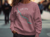 Dusty rose sweatshirt with Lake Chelan Washington compass graphic.