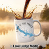 White mug with "Lake O' The Pines" and Texas map design, coffee pouring into it.