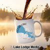 White mug with Clear Lake California map and compass design, with coffee splashing.