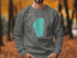 Dark grey sweatshirt with turquoise Lake Tahoe map and compass design.