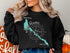 Black sweatshirt with a teal Lake Havasu map and compass design.