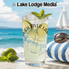 Tall glass of lemonade with mint and lime, compass design, beach scene background.