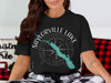 Black t-shirt with Saylorville Lake, Iowa map, compass, and text graphic.