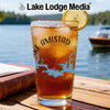 Iced tea with lemon in a glass with "Lake Amistad" text and a Texas map on a table.