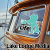 Turquoise Yellowstone Life sticker on a boat window with "Lake Lodge Media" text.