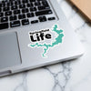 Sticker with "Springfield Life" text and a teal lake outline on a laptop.