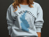 Light blue sweatshirt with Lake Monticello, South Carolina map and compass design.