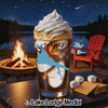 Glass with creamy beverage, Canyon Lake map, and campfire scene.