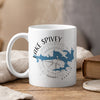 White mug with Lake Spivey Georgia map and compass design, with steam rising.
