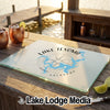 A glass cutting board featuring a Lake Texoma Oklahoma map design rests on a wooden outdoor bar.
