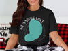 Black t-shirt featuring Newnan's Lake, Florida shape and compass graphic.