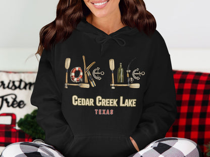 Black hoodie with "Cedar Creek Lake Texas" and nautical graphics.