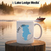 White mug with Lake Piru map and compass design, set on a wooden surface.
