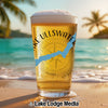 Glass of beer on beach with "Lake Ullswater" text and compass design.