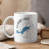 White mug with Cedar Lake, Ontario map and compass design, steaming.