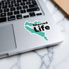 Turquoise Merced Life sticker on a laptop keyboard.