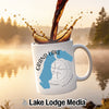 White mug with "Grand Lake Colorado" text and lake map graphic, coffee pouring into it.