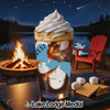 Glass with ice cream and coffee beside s'mores by campfire at night.