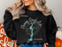 Black sweatshirt with a compass graphic and "Flaming Gorge Lake Wyoming" text.