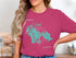 Pink t-shirt with a turquoise outline map of Marco Island and compass rose.