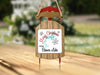 Wooden sled ornament with "Merry Christmas From Beaver Lake" and snowflakes.