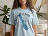 Light blue t-shirt featuring Keechelus Lake, Washington map silhouette graphic.
