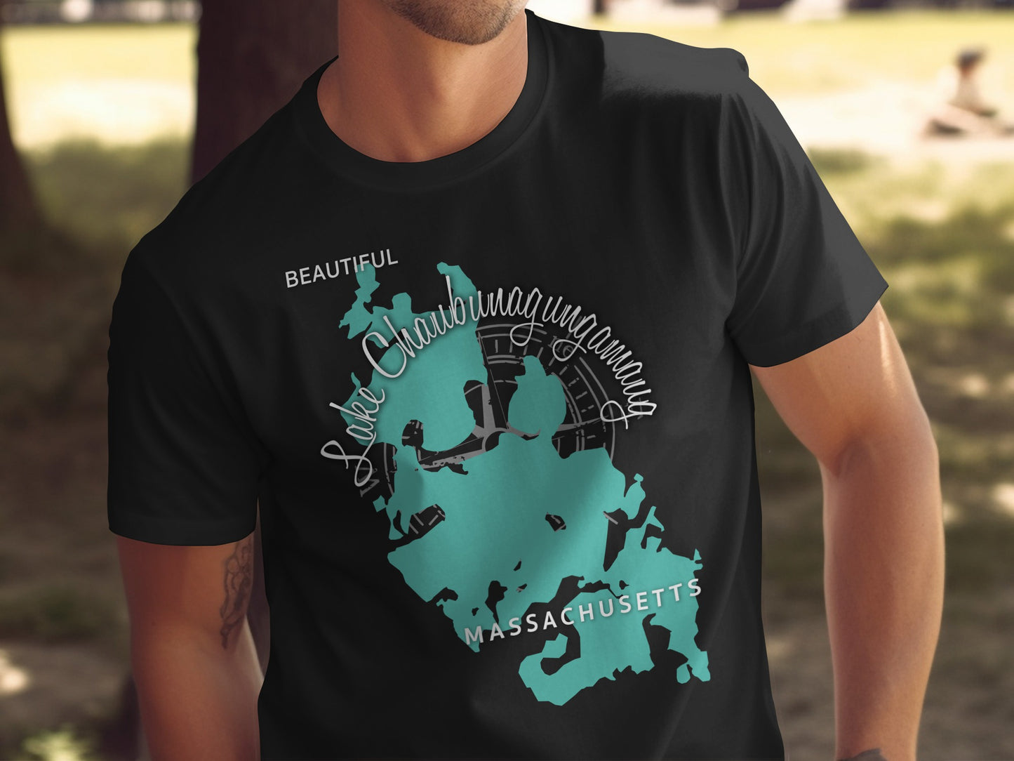 Black t-shirt with teal outline map of Lake Chaubunagungamaug, Massachusetts.