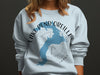 Light blue sweatshirt with Lake Pend Oreille map and compass graphic.