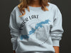 Light blue sweatshirt featuring a map of Prior Lake, MN, and compass graphic.