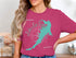 Pink t-shirt with turquoise Lake Las Vegas, Nevada outline and compass rose.