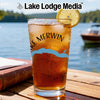 Glass with iced tea, lemon slice, and "Lake Merwin" design, with "Lake Lodge Media" logo.